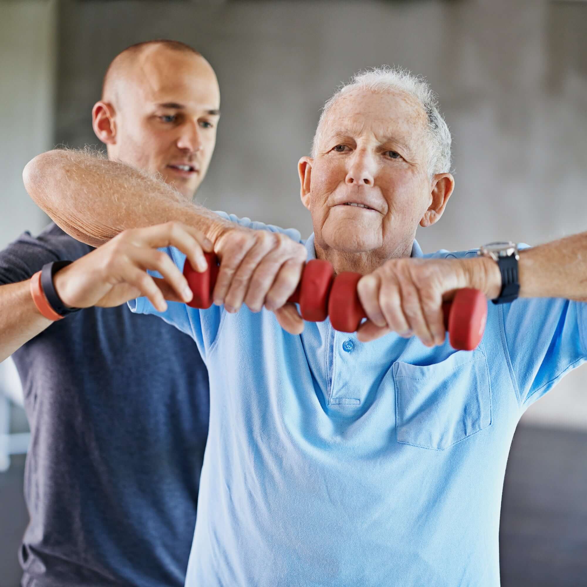 Shot of a senior man working out with the help of a trainer